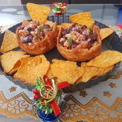 A picture of Nachos basket with mexican salsa.