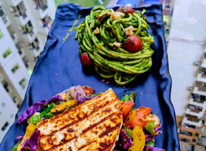 A picture of Pesto Noodles with Grilled Paneer Steak.