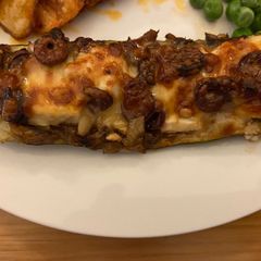 A picture of Mushroom and goats cheese stuffed zucchini.