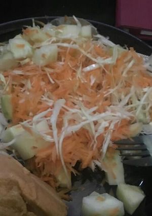 A picture of Moimoi and cole slaw (cabbage, cucumber and carrot).