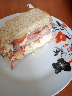 A picture of Avocado, egg, ham and bacon sandwich.