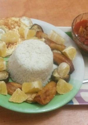 A picture of Rice with stew and plantain.