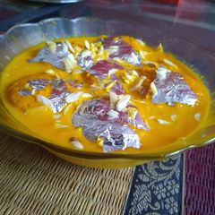 A picture of Orange rasmalai.