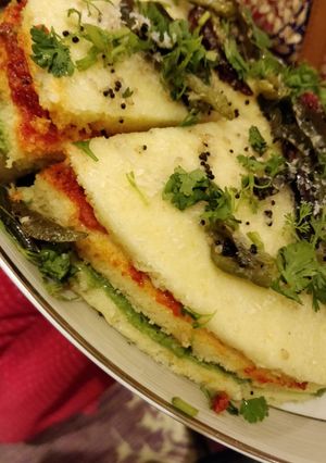 A picture of 3 type of dhokla but layered utapam.