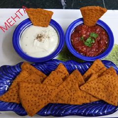 A picture of Lentil Nachos with salsa and sauce.