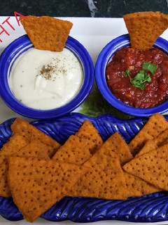 A picture of Lentil Nachos with salsa and sauce.