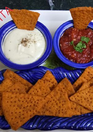 A picture of Lentil Nachos with salsa and sauce.