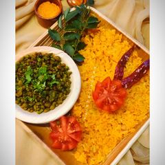 A picture of Tomato Rice with Palak Boondi.