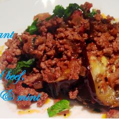 A picture of Eggplant with crumbed beef, tomato and mint.