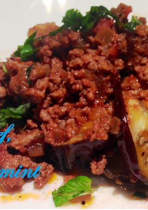 A picture of Eggplant with crumbed beef, tomato and mint.
