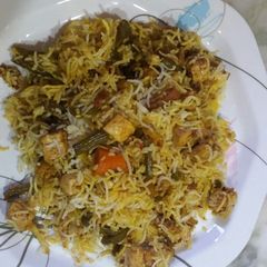 A picture of Veg paneer biryani with dry aloo bukhara.