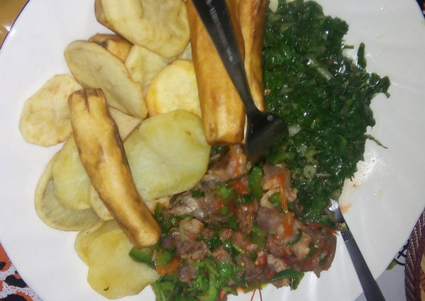Deep fried potatoes and green bananas served with beef stew and spinach