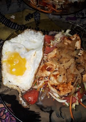 Una foto de Pollo grillé con ensalada y huevo a la plancha