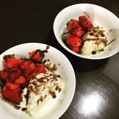 A picture of Strawberry with ice cream and balsamic sauce.