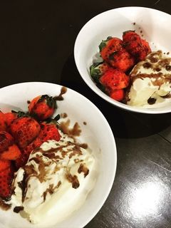 A picture of Strawberry with ice cream and balsamic sauce.