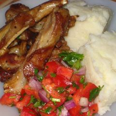 A picture of Mashed potatoes, pan grill ribs and simple tomatoes salad.