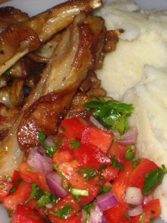 A picture of Mashed potatoes, pan grill ribs and simple tomatoes salad.