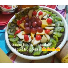 A picture of Chocolate biscuits fruit pizza totally unique.