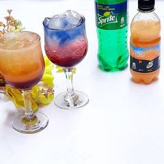 A picture of Sunrise and layered blue paradise mocktail.
