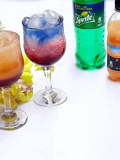 A picture of Sunrise and layered blue paradise mocktail.