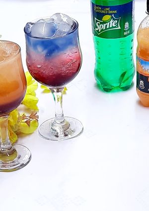 A picture of Sunrise and layered blue paradise mocktail.