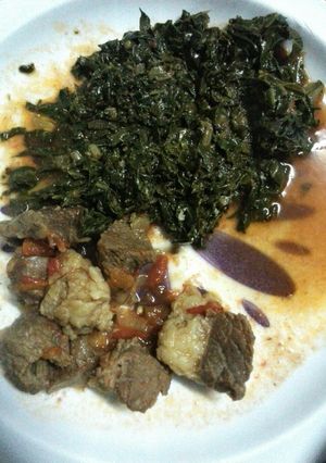 A picture of Beef stew and kales.
