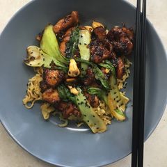A picture of Cashew chicken with egg fried noodles.
