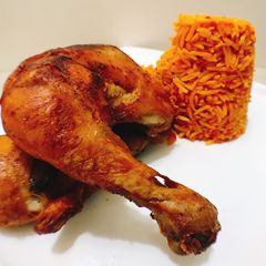 A picture of Spicy fried chicken and jollof rice.