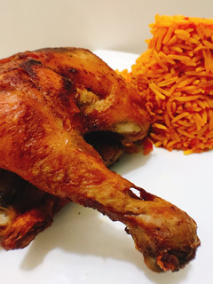 A picture of Spicy fried chicken and jollof rice.