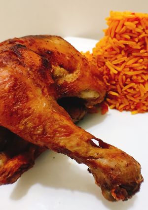 A picture of Spicy fried chicken and jollof rice.