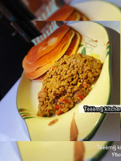 A picture of Pancake with minced meat sauce.