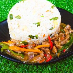 A picture of White fried rice and shredded sauce.