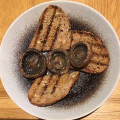 A picture of Juicy portabellini mushrooms on seedy toast.