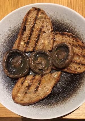A picture of Juicy portabellini mushrooms on seedy toast.