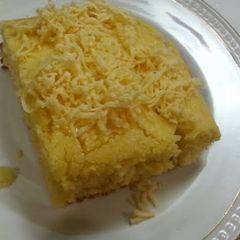 A picture of Corn bread top w/ cheese.