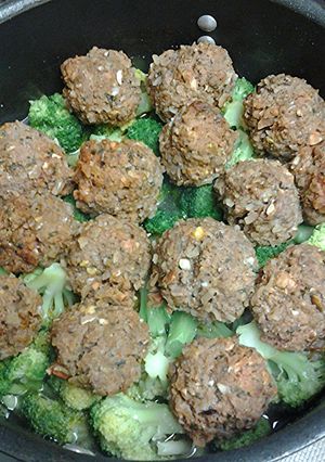 A picture of Kofta on a bed of broccoli.