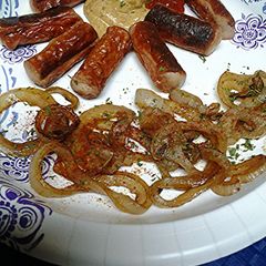 A picture of Vienna sausages and naked onion rings.