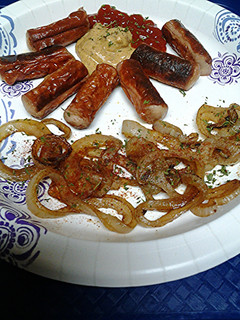 A picture of Vienna sausages and naked onion rings.