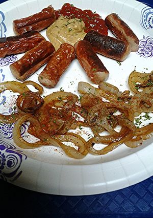 A picture of Vienna sausages and naked onion rings.