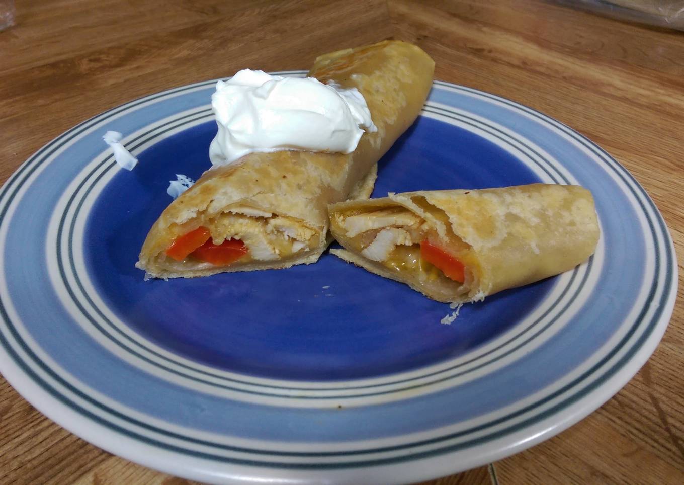 Seasoned Chicken & cheese wrap with bell peppers and sour cream.