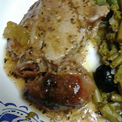 A picture of Roasted onions and pork.
