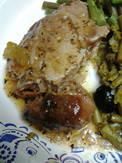 A picture of Roasted onions and pork.