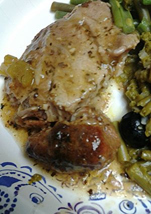 A picture of Roasted onions and pork.