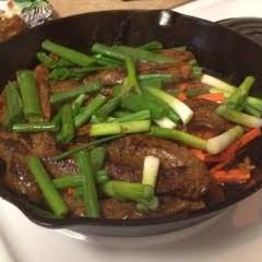 A picture of Salty, sweet and spicy flank steak with creamy avacado-cilantro sauce.