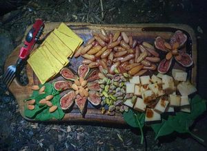 Una foto de Tabla de queso de cabra, mostaza y miel, piñones e higos