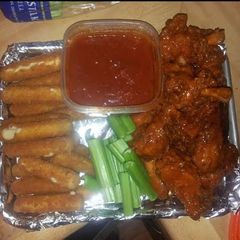 A picture of Gameday food homemade wings & mozzarella cheese sticks with marinara sauce.