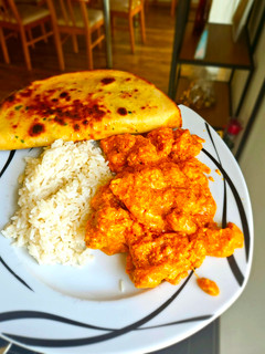 A picture of Chicken Tikka Masala with Naan bread.