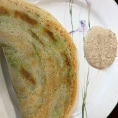 A picture of Dosa or rice crepe with mashed potato & avacado.