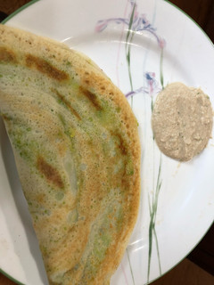 A picture of Dosa or rice crepe with mashed potato & avacado.