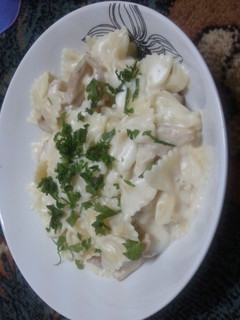 A picture of pasta with white sauce and chicken.
